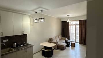 Signature Condo, 1 Queen Bed with Sofa bed, Kitchenette | Living room | 35-inch Smart TV with digital channels