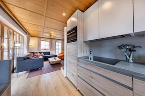 A modern kitchen with wooden cabinets, a countertop, and a built-in oven.