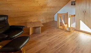 Relax in this inviting loft-style room with a bench and wooden table.