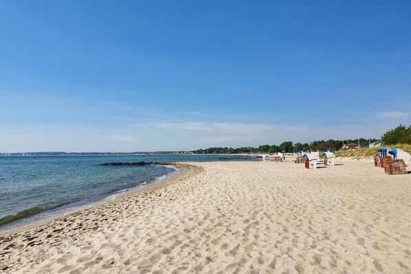 On the beach, sun-loungers