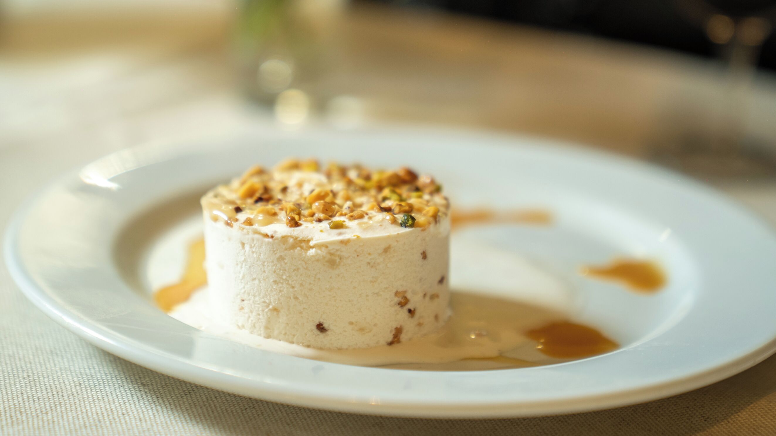 A dessert on a plate with a sauce spill.