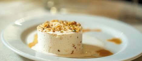 A dessert on a plate with a sauce spill.