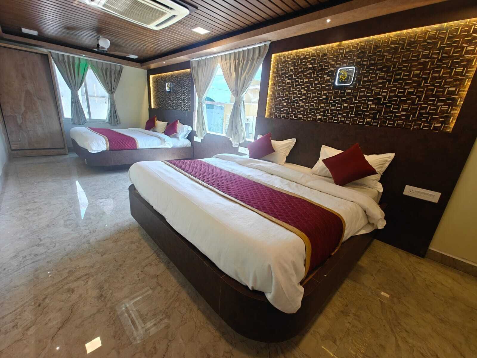A hotel room with two beds, a modern design, and a decorative wall panel.