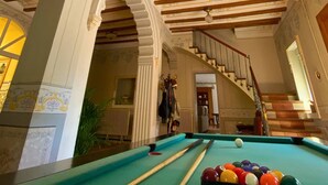 A pool table with balls, a chandelier, and ornate ceiling with wooden beams and decorative patterns. - Room-magnolia Loft A Spacious, Authent (Alzira)