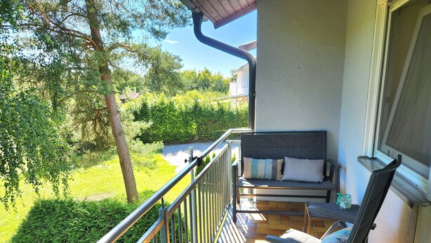 A balcony with a chair, a bench, and a railing. - Holiday flat ‘Silvaner’ with private balcony, shared terrace and communal garden (Iphofen)