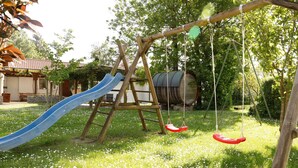A playground with a slide and swings. - Holiday Apartment 'Riesling' with Private Balcony, Shared Terrace (Iphofen)