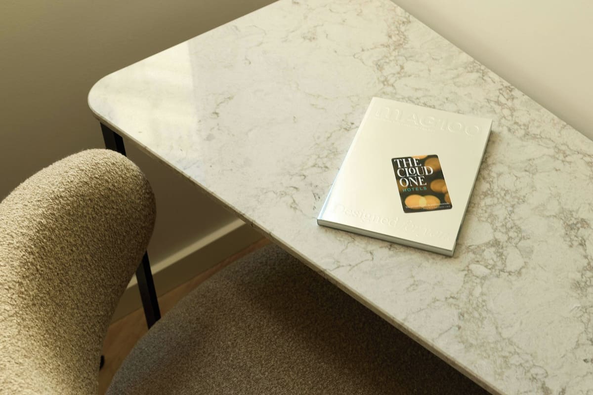 A marble table with a book titled 'The Cloud One Hotels' on it.