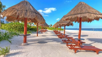 On the beach, sun-loungers, beach towels