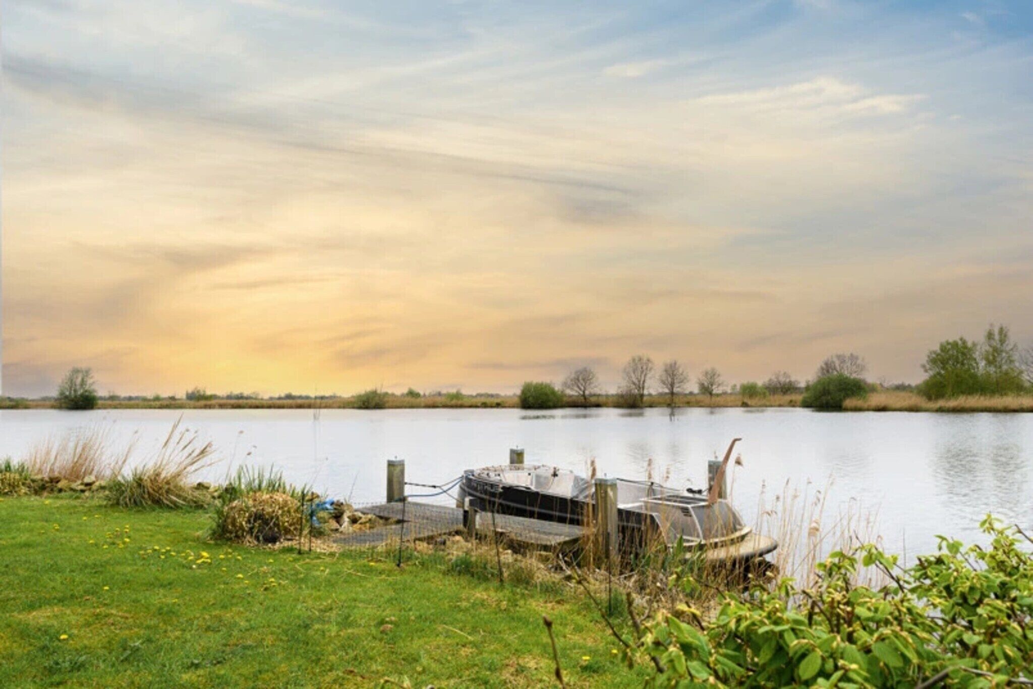 A lakeside property with a dock and a small boat.