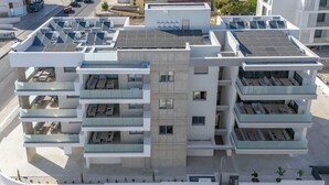 A modern multi-story building with balconies, solar panels, and a nameplate reading "MULBERRY COURT". - Mulberry Court Premium Apartments (Limassol)