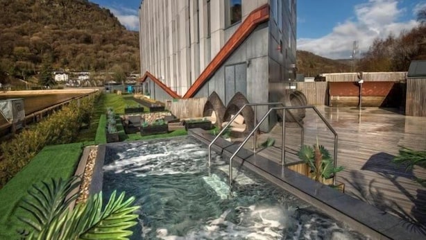 A modern building with a water feature in front.