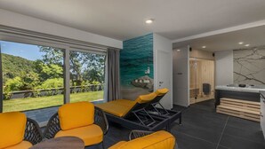 A modern room with a large window, yellow chairs, a small table, and a sauna area. - NEW! Villa with 6 Bedrooms and Heated Pool (Moscenicka Draga)