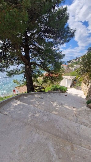 A concrete staircase leading up to a building with a view of the sea. - Azure Apartments By The Sea with 3 Bedrooms (Omis)