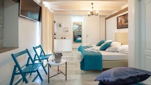 A room with a bed, two chairs, a small table with a bucket, and a chandelier. - NEW! Lovely Villa With Heated Pool and Sea View (Omis - Split Region)