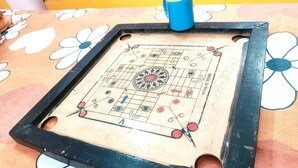 A table with a checkered pattern and a blue cup on it. - Kovo Expo Mart (Greater Noida)