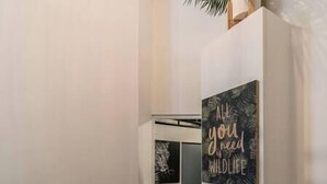 A hallway with a wall-mounted sign that reads "ALL you need WILDLIFE." - Splendid 8-room apartment near Bercy (Paris)