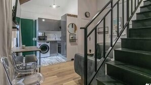 Un interior moderno con una escalera, un comedor y una cocina.