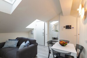 Deluxe Condo | Living area | 40-inch Smart TV with digital channels - notaMi - Bright Attic M4 - 2 Bedrooms (Milan)