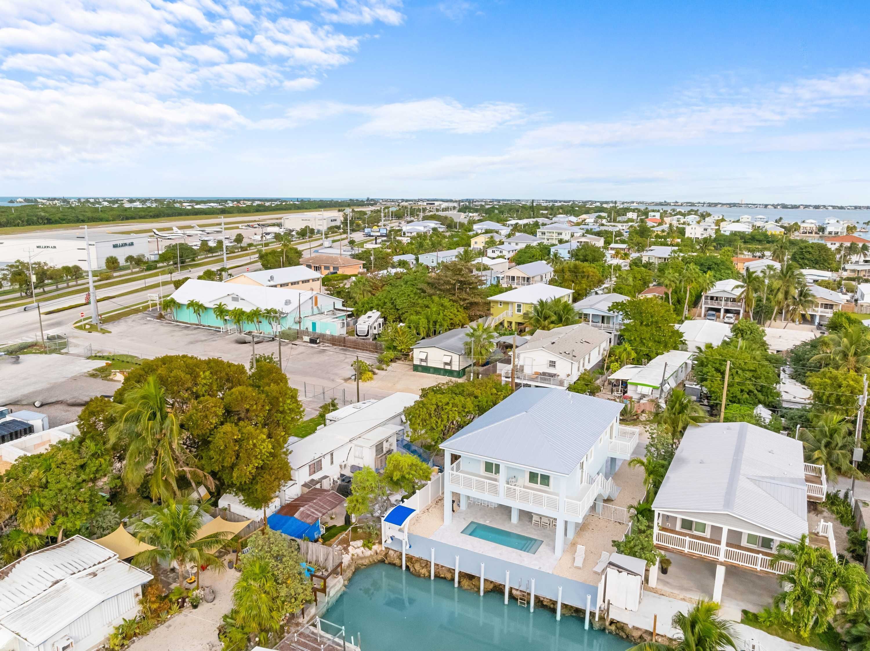 A residential area with houses, a swimming pool, and a marina.