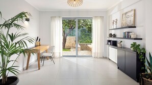 Une cuisine moderne avec un coin repas, une grande fenêtre et un luminaire au plafond.