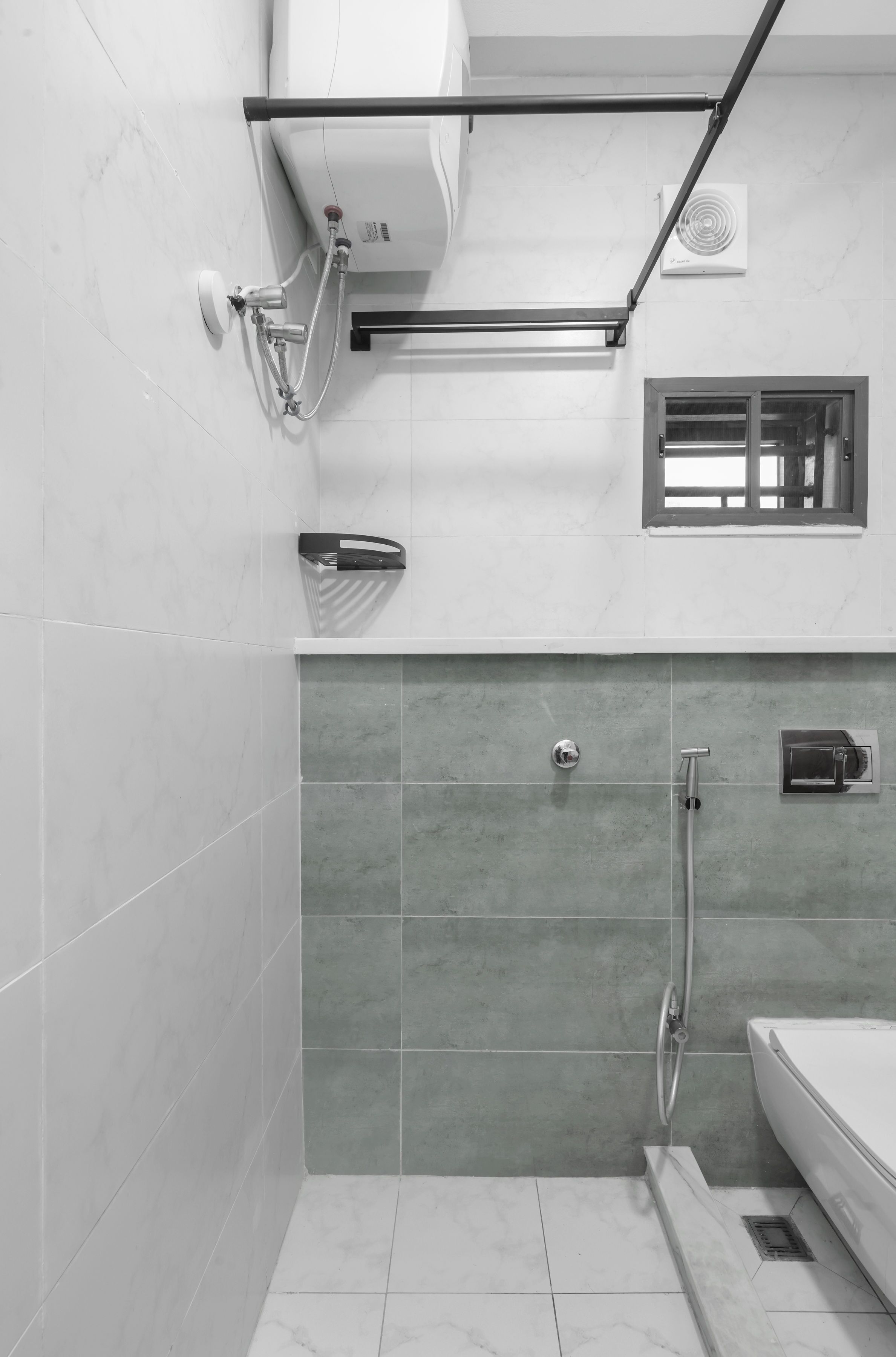 A modern bathroom with a shower, a toilet, and a sink.