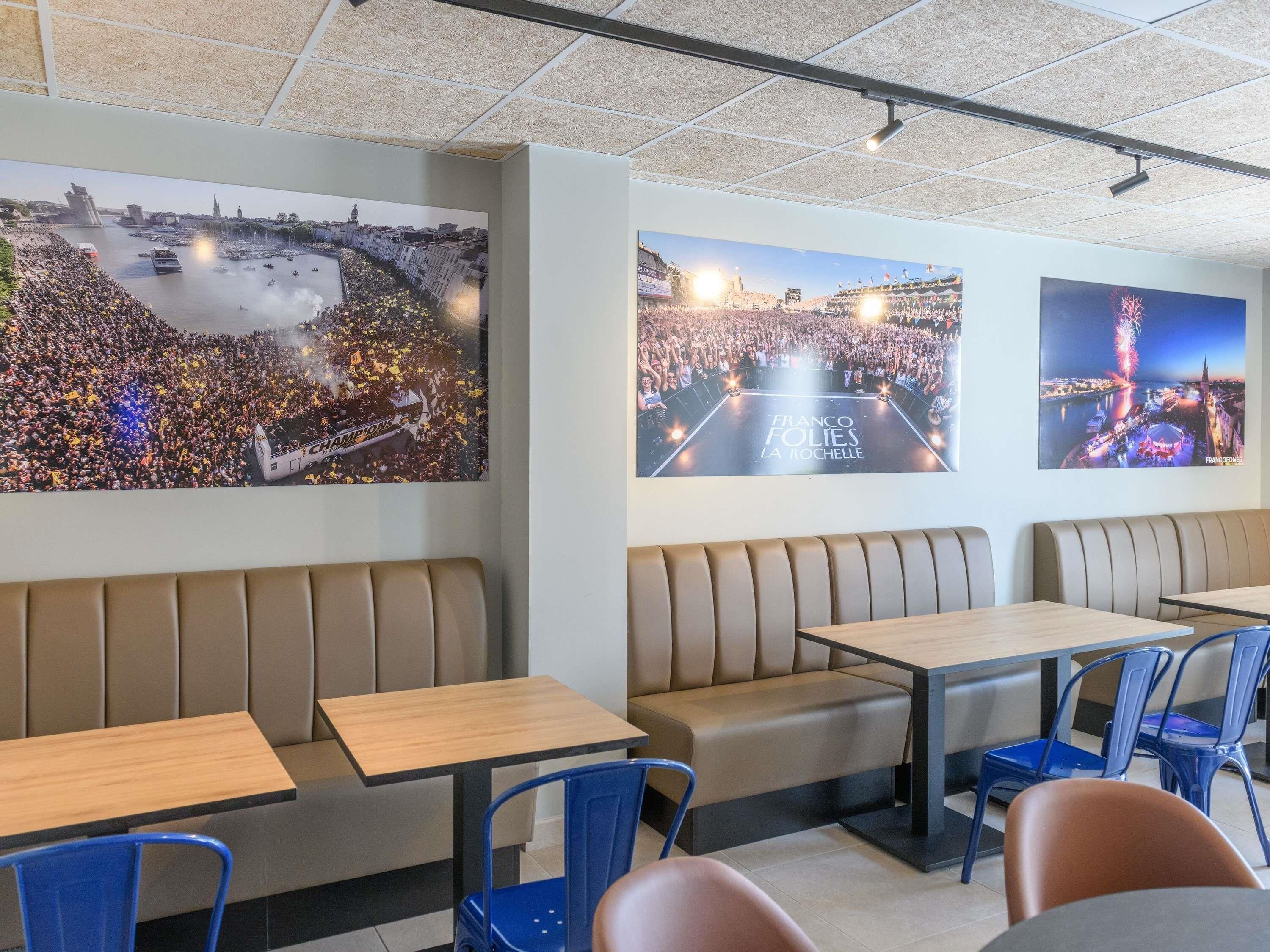 A restaurant interior with booths, tables, and chairs.