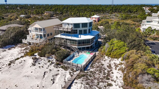 A large, multi-story house with a pool, surrounded by trees and sand. - Huge 6 Bdrm/6+ Ba Private GF Home, Pool, Dune Walkover, Easy Access, Gulf Views (Gulf Shores)