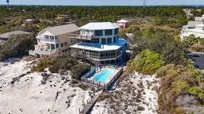A large, multi-story house with a pool, surrounded by trees and sand. - Huge 6 Bdrm/6+ Ba Private GF Home, Pool, Dune Walkover, Easy Access, Gulf Views (Gulf Shores)