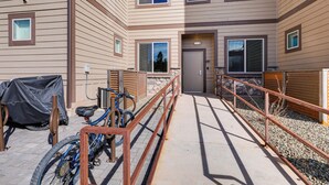 A multi-story building with a covered bike rack, a covered bicycle, and a gravel pathway leading to the entrance. - 1 Mi to Dtwn Flagstaff: Condo w/ 2 Balconies! (Flagstaff)