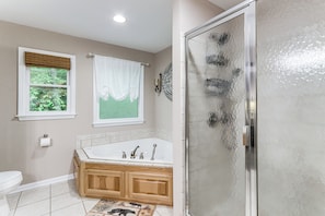 A bathroom with a bathtub, a shower, and a toilet.