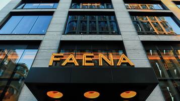 A building with the sign "FAENA" prominently displayed.