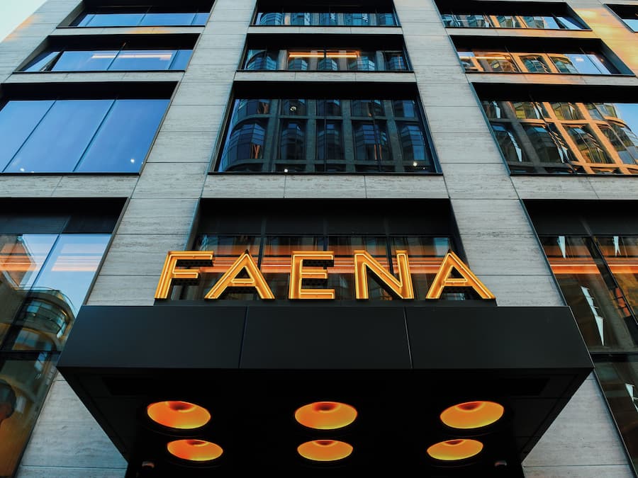 A building with the sign "FAENA" prominently displayed.