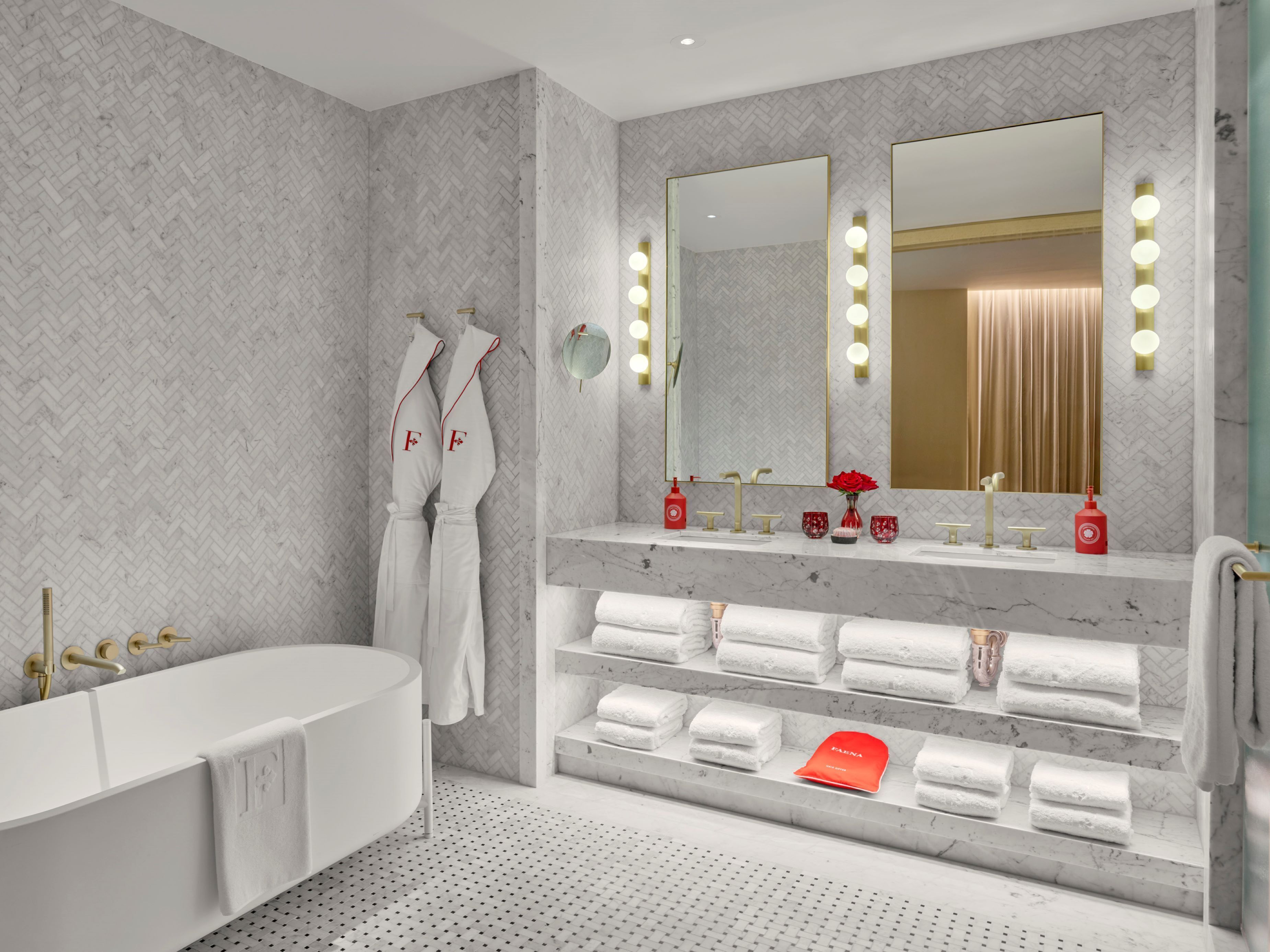 A modern bathroom with a freestanding bathtub, a vanity with a mirror, and a towel rack.