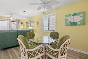 Cozy living space with a round dining table and four chairs, perfect for family meals.