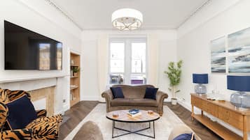 Standard Apartment | Living area | 24-inch flat-screen TV with cable channels, TV