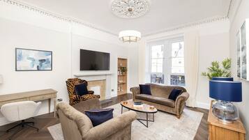 Standard Apartment | Living area | 24-inch flat-screen TV with cable channels, TV