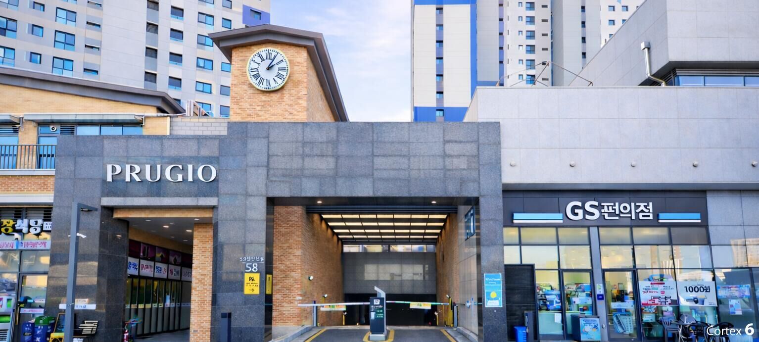 A modern building with a clock tower, labeled "PRUGIO," and a store named "GS 전위전."