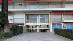 A building with a glass entrance labeled 'LE MARLY' and a red awning. - 55-"Le rêve éveillé", vue mer, garage 38 (Menton)