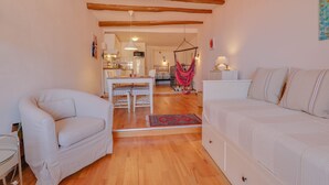 A living room with a sofa, a chair, a dining table, and a kitchen in the background. - 14-"La Belle Vue Mer" Cozy Appartement, Centre, Pl (Menton)