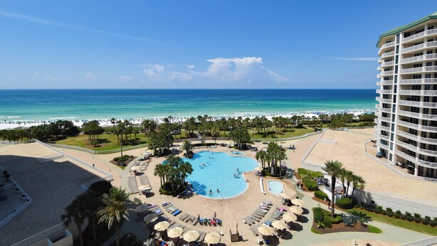 A resort with a central swimming pool, beach area, and a high-rise building. - Stunning beachfront condo w/ relaxing amenities in the heart of Destin! 🐚🏖🐟 (Destin)