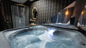 A modern bathroom with a large hot tub, a glass-enclosed shower, and a vanity with a mirror. - Hacienda d'Amore (Oletta)