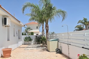 Experience a tranquil retreat in our serene courtyard with a palm tree, water feature, and lush garden.