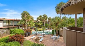 A courtyard with a pool, lounge chairs, and palm trees. - Big Fun, Small Price—Your Orlando Escape! (Kissimmee)