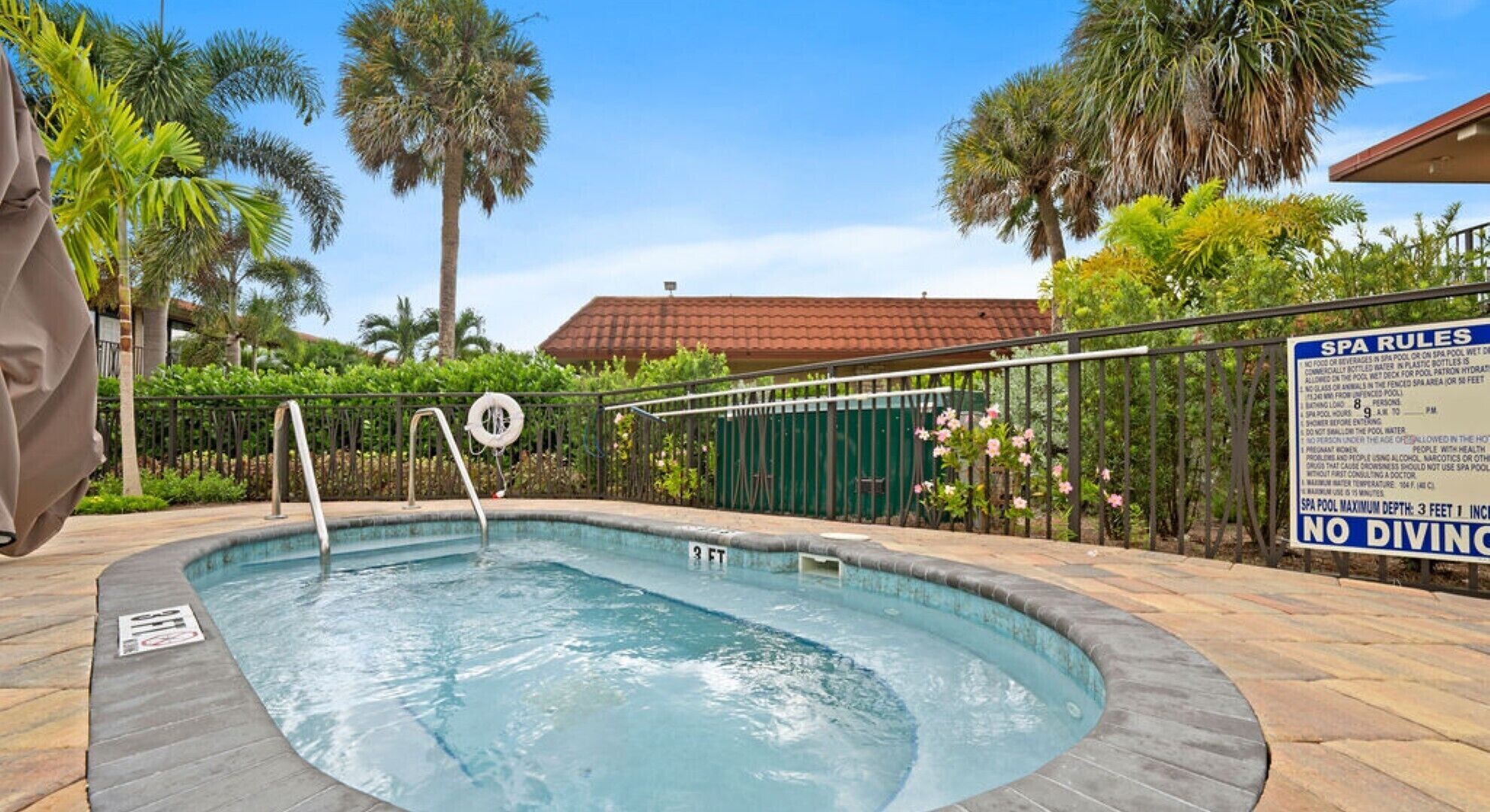 A spa pool with a sign indicating a maximum depth of 3 feet and a no diving rule.