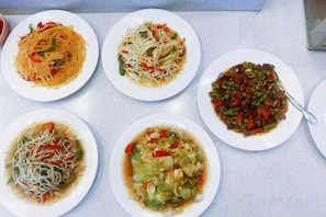 A table with five plates of food.