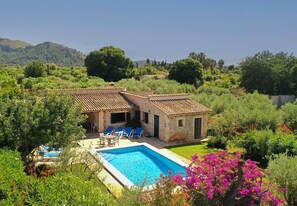 A villa with a swimming pool, surrounded by lush greenery and hills. - Villa Oliveres, Beautiful villa in the countryside near Pollensa (Pollença)