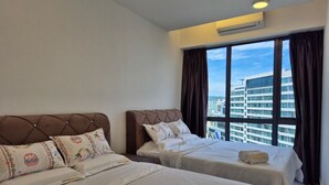 A hotel room with two beds, a large window with curtains, and a view of buildings. - Sutra Bay (Kota Kinabalu)