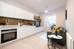 Leilighet – standard | Oppholdsområde | En 24-tommers Flatskjerm-TV med kabel-kanaler samt TV