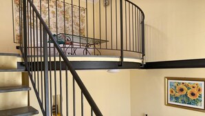 A spiral staircase with black railings leading to an upper level. - Suite Family Room with Attic and View, use of two pools at Casale del Vacanziere (Toscana)