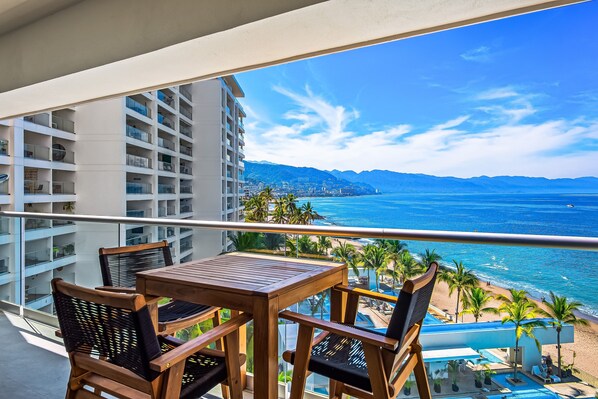 Outdoor dining - Elegant beachfront condo with stunning ocean views, heated pools & gym access (Puerto Vallarta)